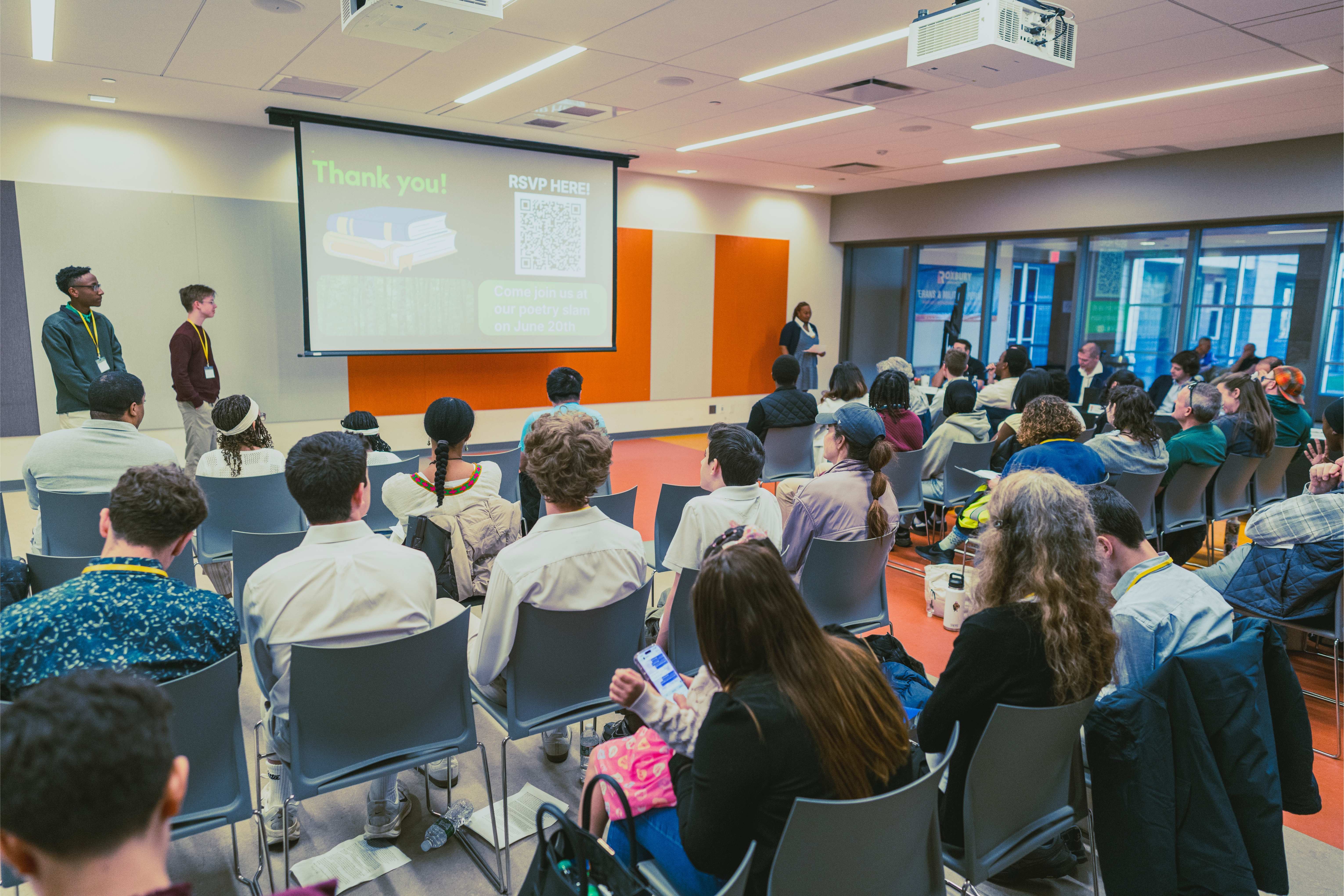Audience listens to the Bridge-building Track judges providing feedback to the youth leaders of MA Youth Climate Coalition.