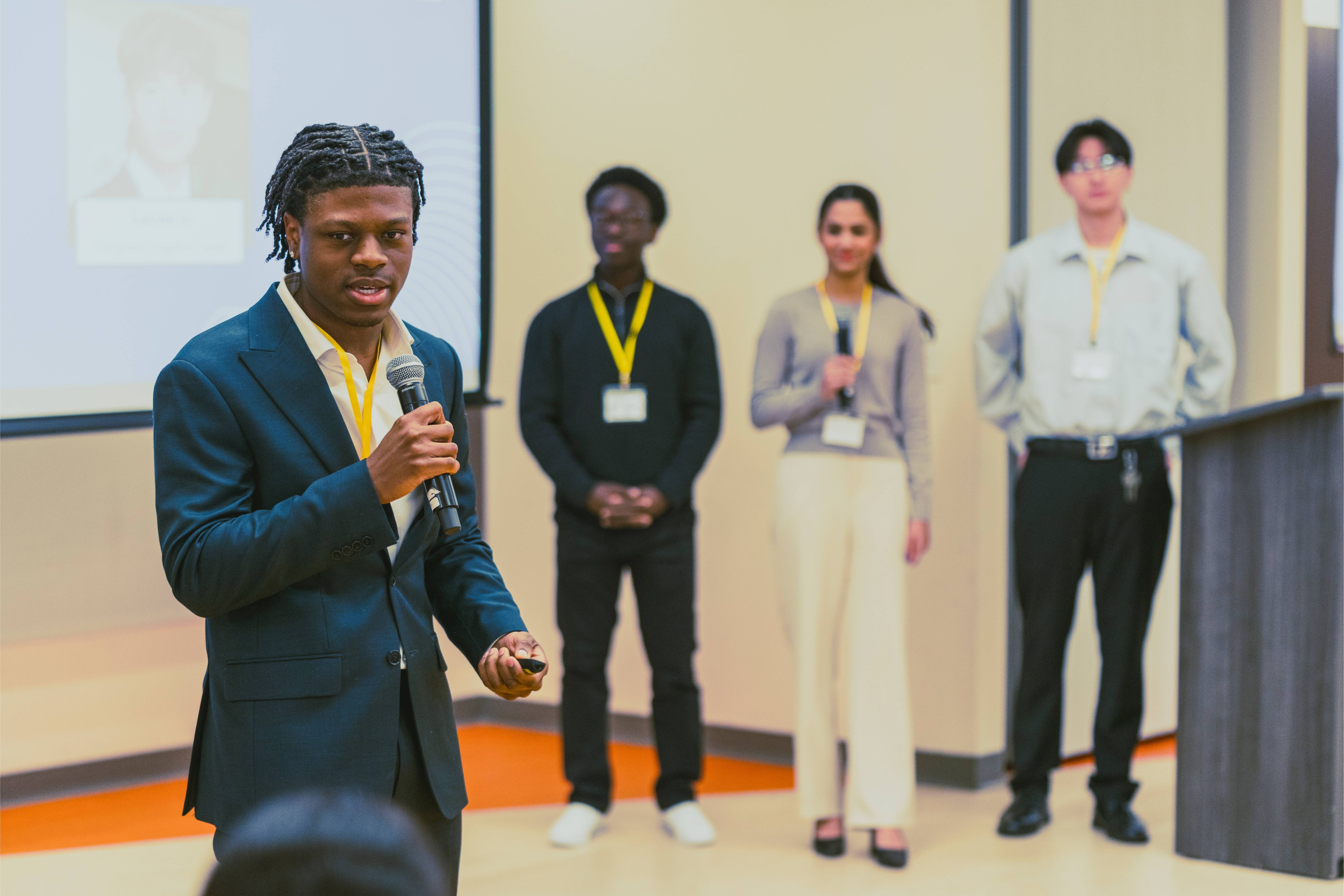 Daniel Idenudia, Founder and Executive Director of Fortune Avenue, presenting to judges and audience members.